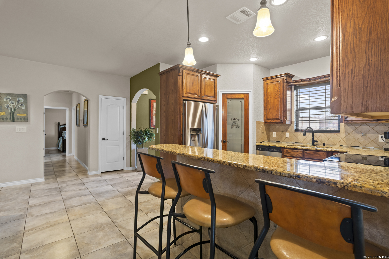 500 Wagon Train Road La Vernia, TX 78121 - Photo 11 of 44 a large kitchen with granite countertop lots of counter space and window
