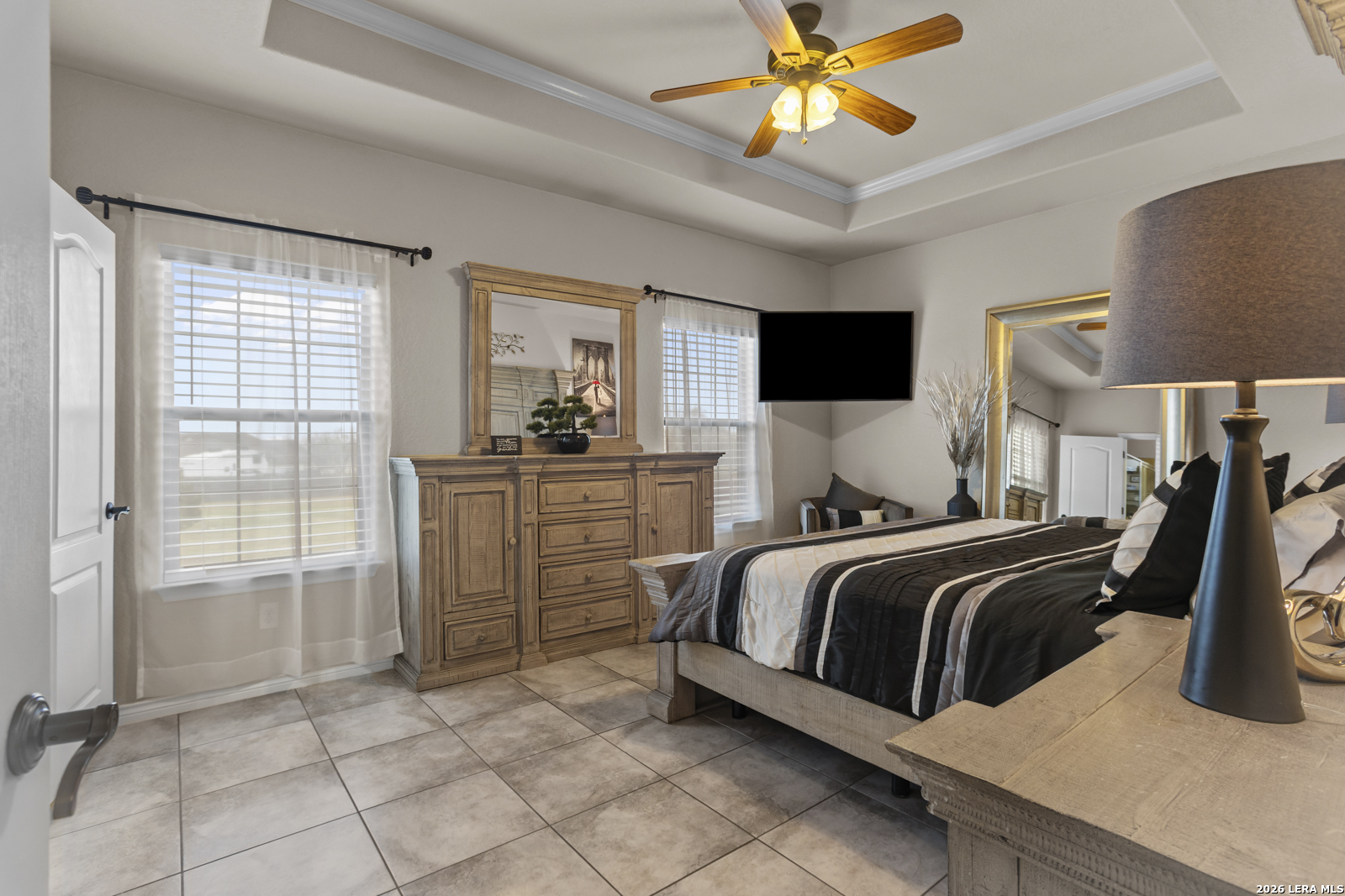 500 Wagon Train Road La Vernia, TX 78121 - Photo 17 of 44 a bedroom with a bed and a chandelier