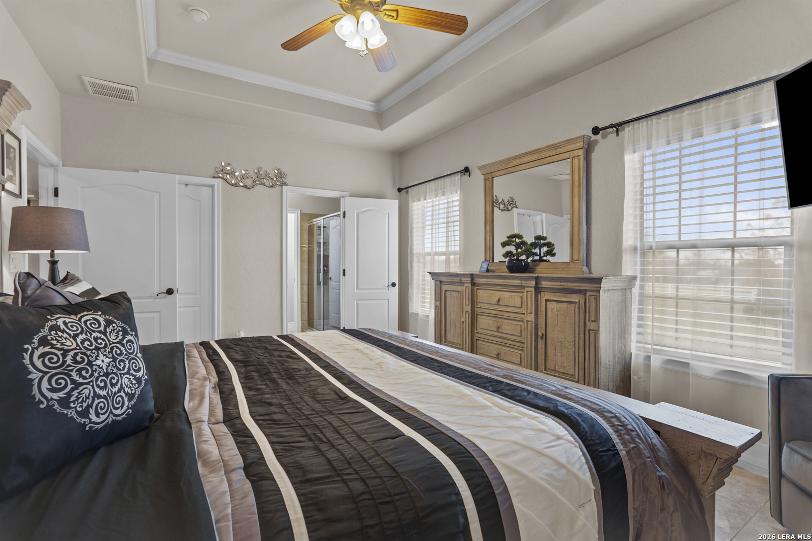 500 Wagon Train Road La Vernia, TX 78121 - Photo 18 of 44 a bedroom with a bed and a chandelier