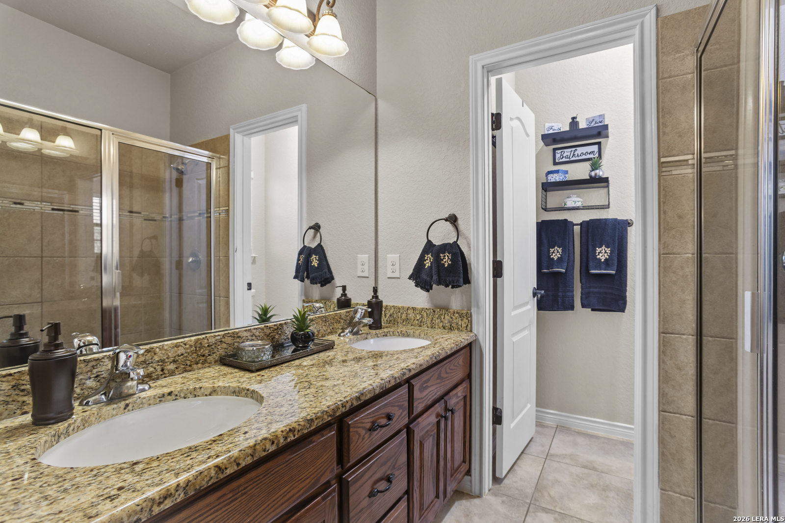 500 Wagon Train Road La Vernia, TX 78121 - Photo 20 of 44 a bathroom with a granite countertop sink and a mirror