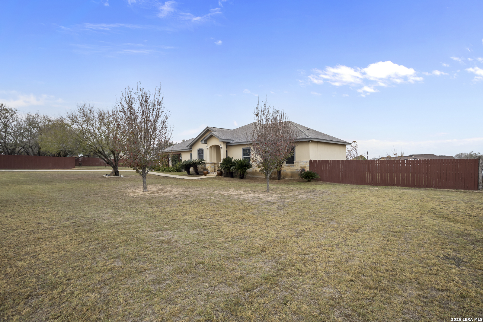 500 Wagon Train Road La Vernia, TX 78121 - Photo 2 of 44 a front view of a house with a yard and mountain view in back