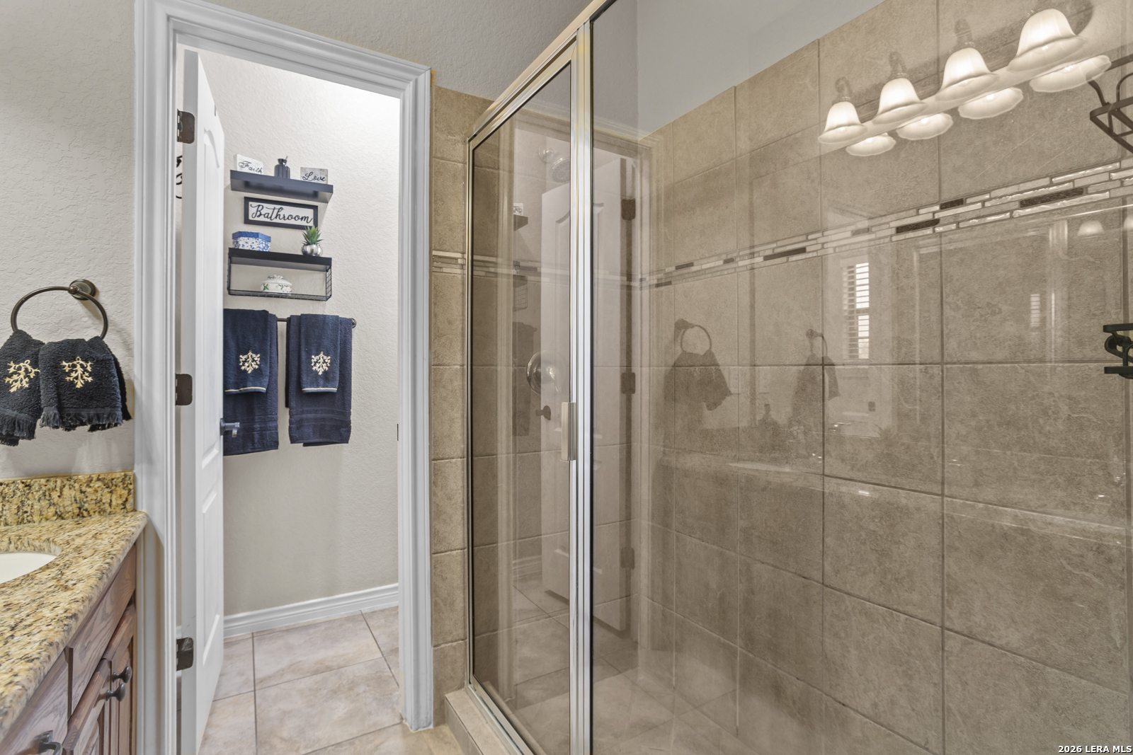 500 Wagon Train Road La Vernia, TX 78121 - Photo 21 of 44 a bathroom with a granite countertop shower a sink and a mirror