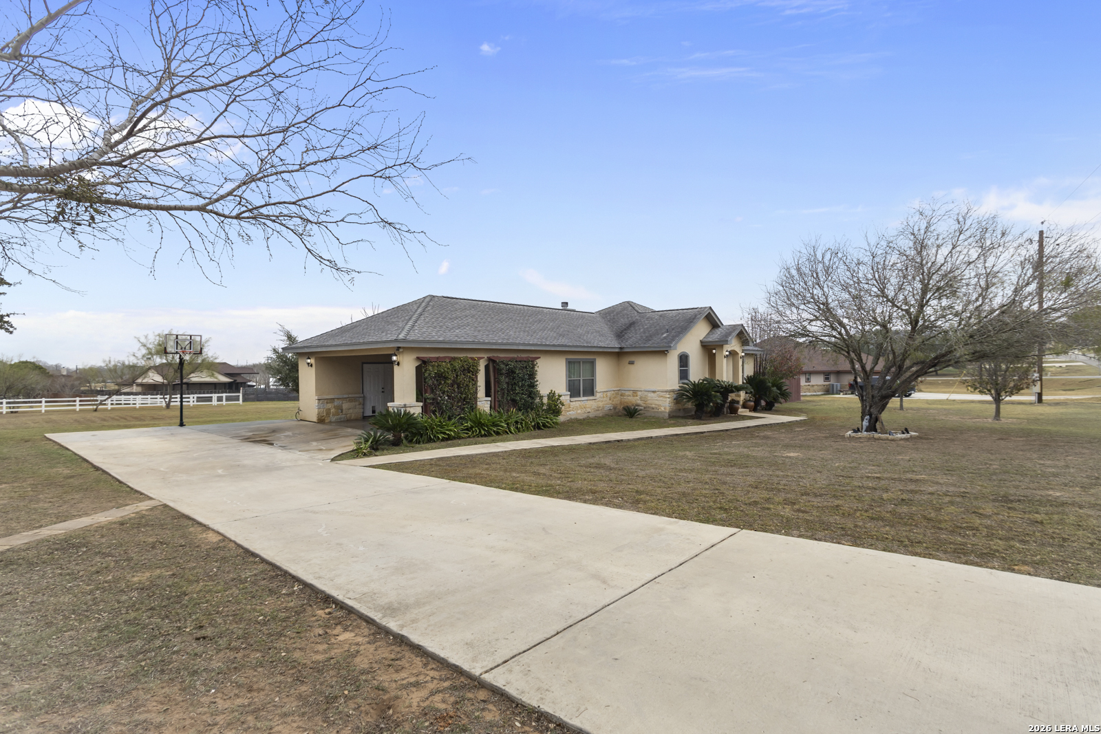 500 Wagon Train Road La Vernia, TX 78121 - Photo 3 of 44 a front view of a house with a yard and garage
