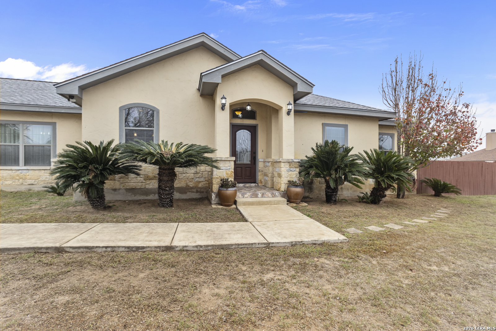 500 Wagon Train Road La Vernia, TX 78121 - Photo 4 of 44 a view of a house with patio outdoor plants and palm trees
