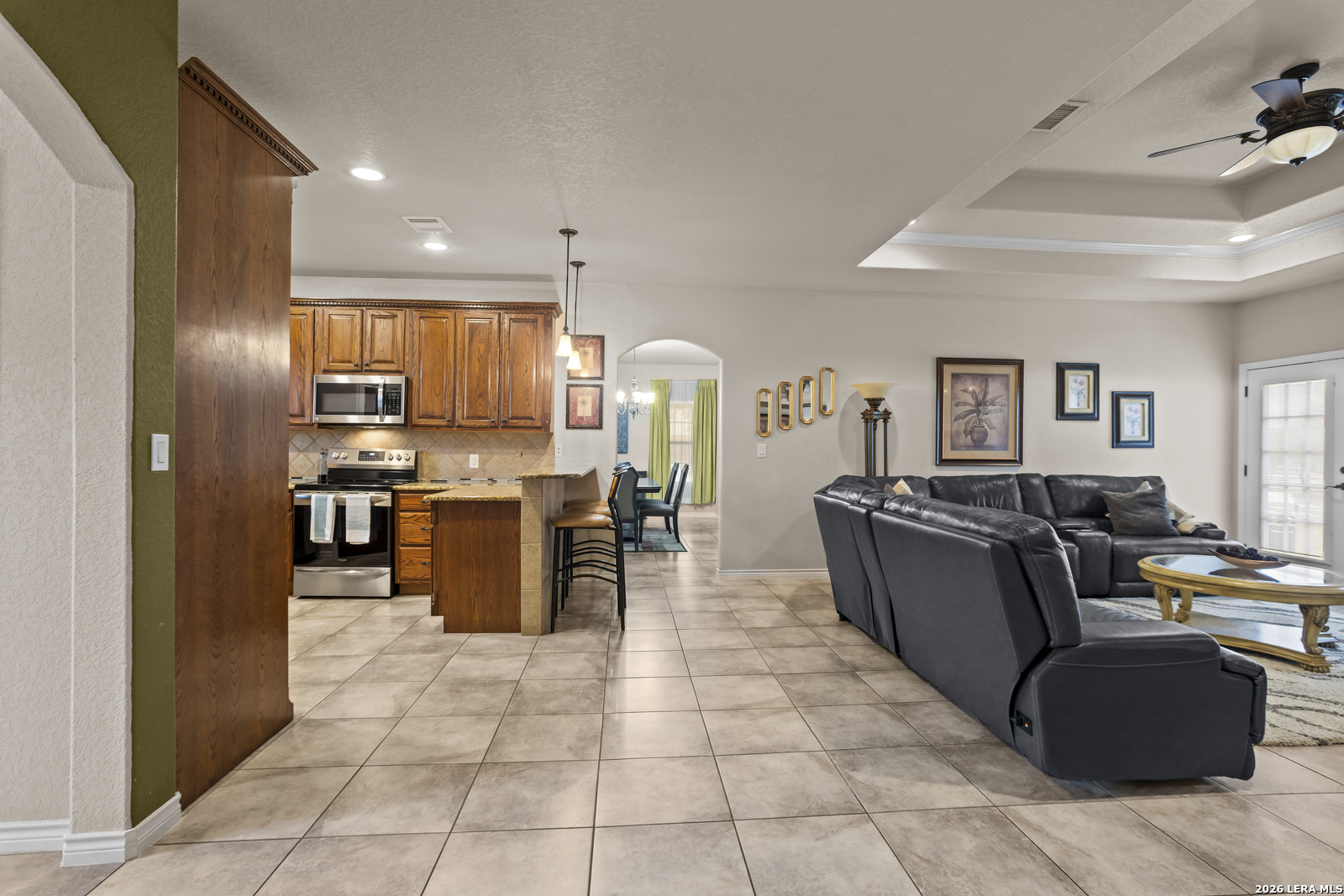 500 Wagon Train Road La Vernia, TX 78121 - Photo 8 of 44 a living room with couches and kitchen view of kitchen