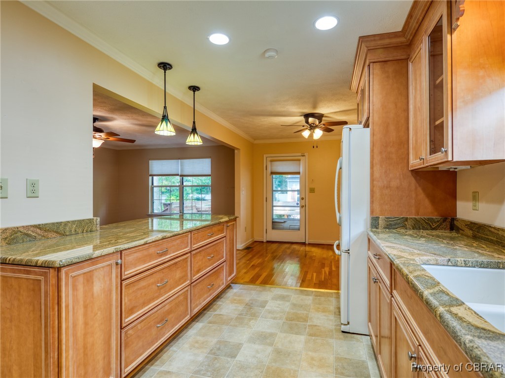 6 Ruth Circle Hampton, VA 23666 - Photo 8 of 50 Kitchen featuring ceiling fan, crown molding, white fridge, and light tile patterned floors