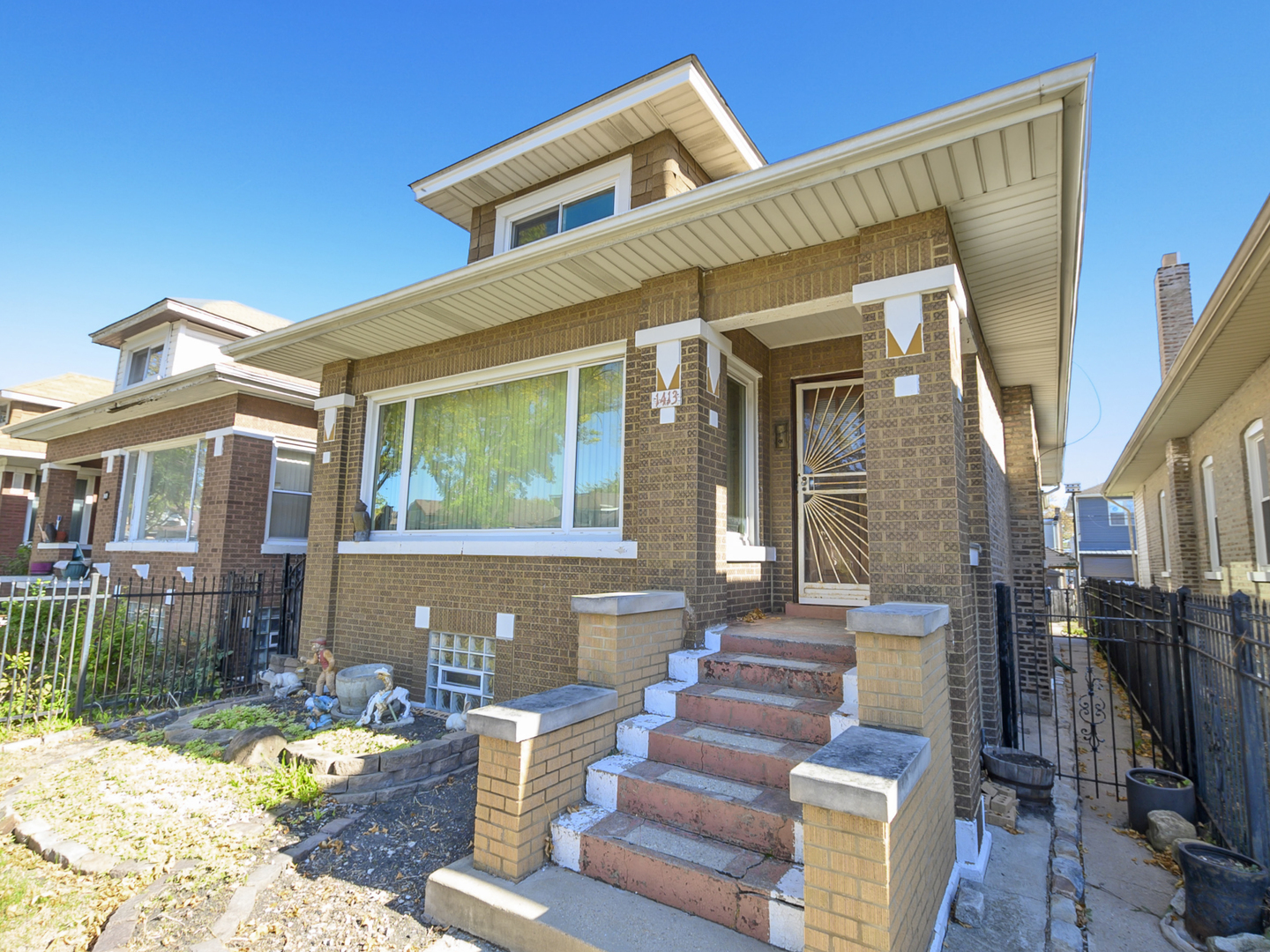 1413 North Long Avenue Chicago, IL 60651 - Photo 2 of 16 a front view of a house with garden