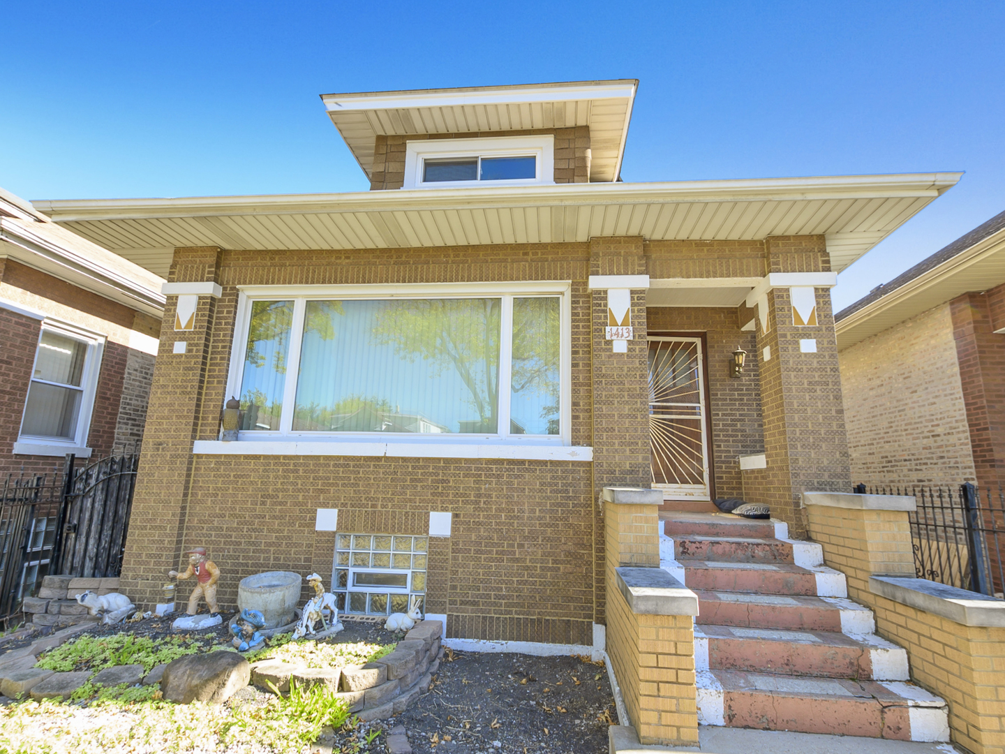 1413 North Long Avenue Chicago, IL 60651 - Photo 3 of 16 a front view of a house with a patio