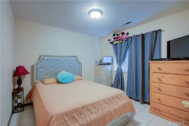 a bedroom with a bed and a dresser