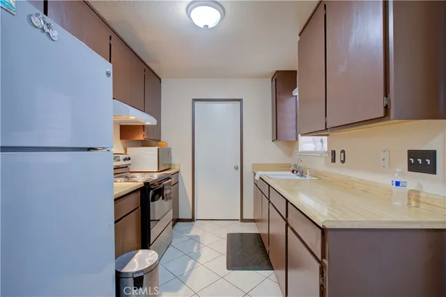 a kitchen with a sink appliances and cabinets