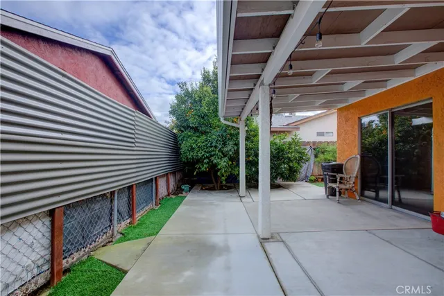 a view of a patio with a table and chairs and potted plants