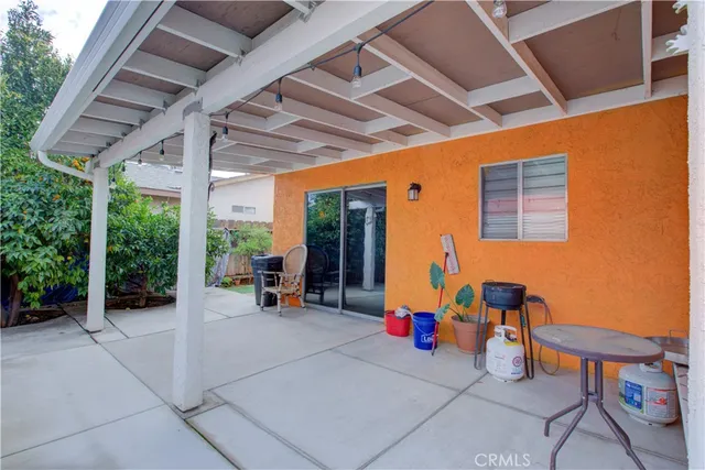 a view of a patio with table and chairs and potted plants