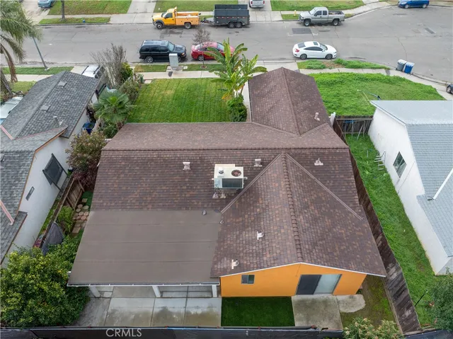 an aerial view of a house with a garden and yard