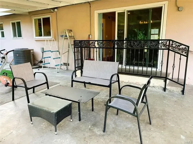 a building outdoor space with patio furniture and garden