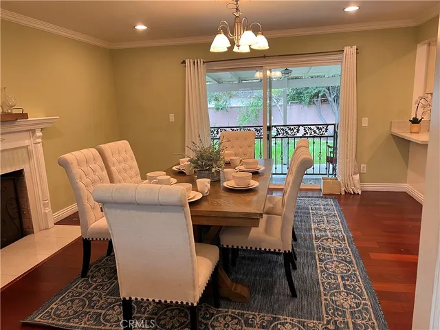 a view of a dining room with furniture wooden floor and a chandelier