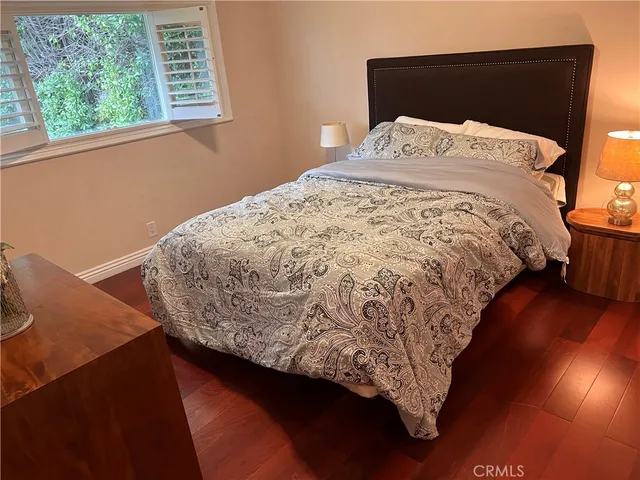 a bed sitting in a bedroom next to a window