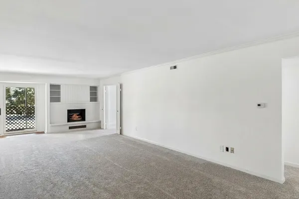 a view of a livingroom with a fireplace and a window