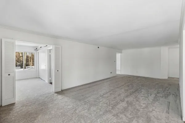 a bedroom with a bed a lamp and a window