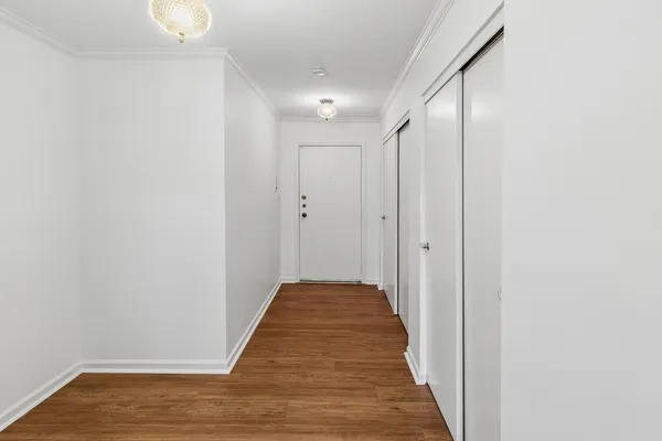 a view of a hallway with wooden floor