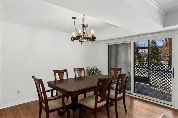 a view of a dining room with furniture wooden floor and chandelier