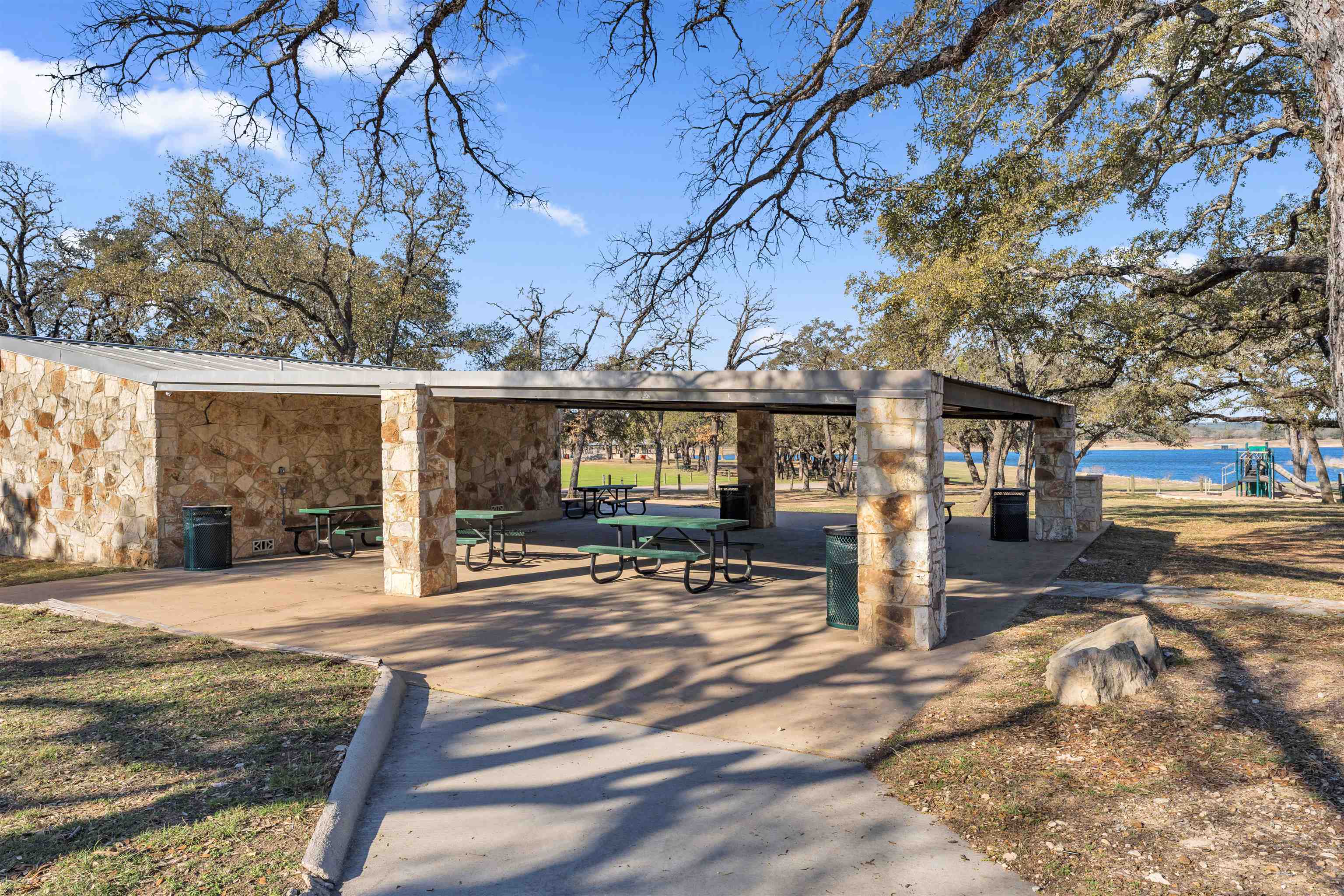 8614 Bar K Ranch Road Lago Vista, TX 78645 - Photo 25 of 26 a view of a building with a bench in a yard