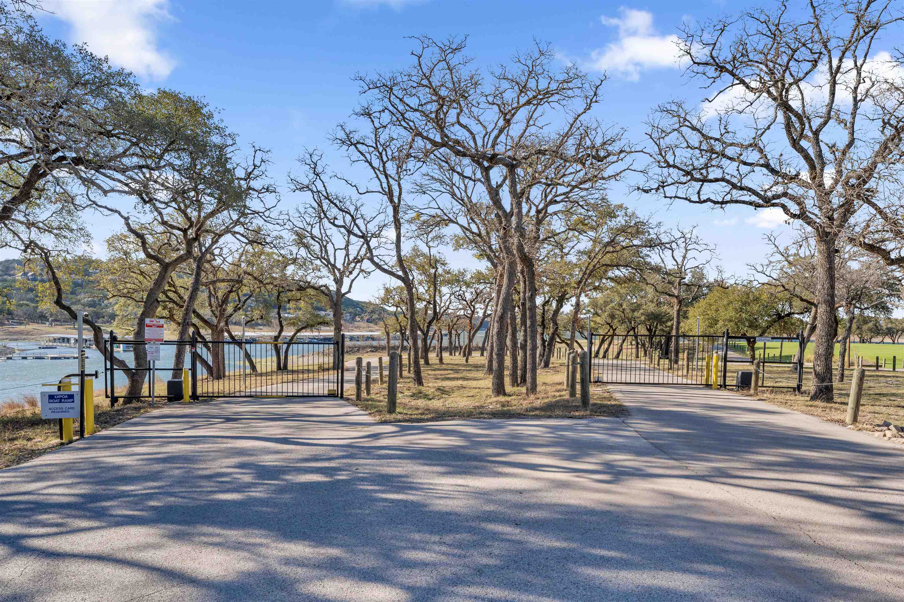 8614 Bar K Ranch Road Lago Vista, TX 78645 - Photo 26 of 26 a street view with large trees