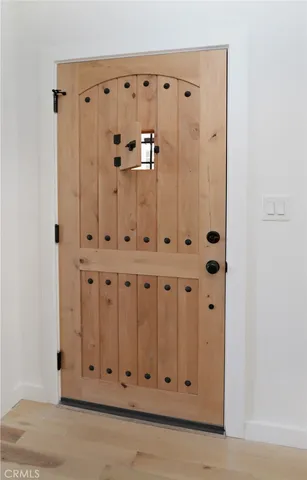 a bedroom with a bed and a lamp on dresser