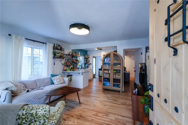 a view of a small space with wooden floor and a window