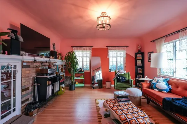 a living room with furniture and a dining table