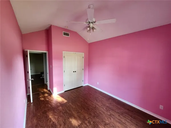 a view of a livingroom with a ceiling fan and window