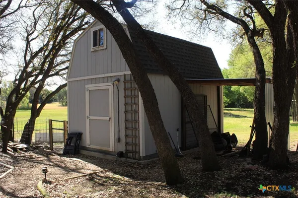 a view of backyard with large trees