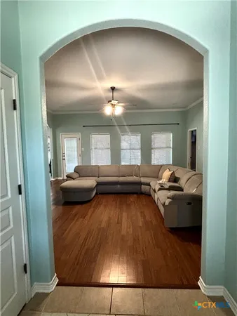 a living room with furniture and a wooden floor