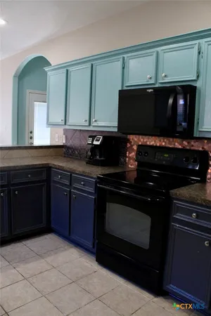 a kitchen with a sink and a stove top oven