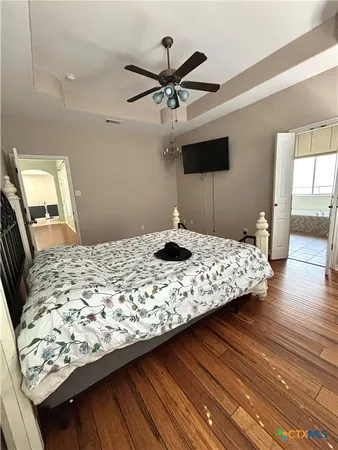 a bedroom with a bed and a flat screen tv