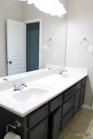 a bathroom with a sink vanity and a mirror