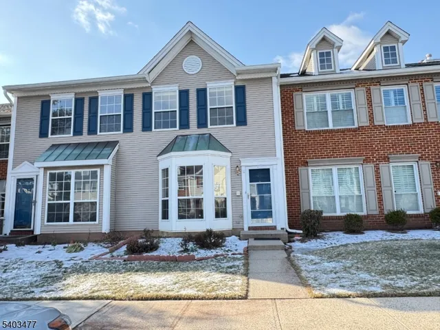 a view of a brick house with large windows