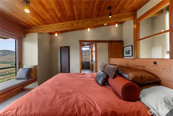 a bedroom with a large bed and a large window