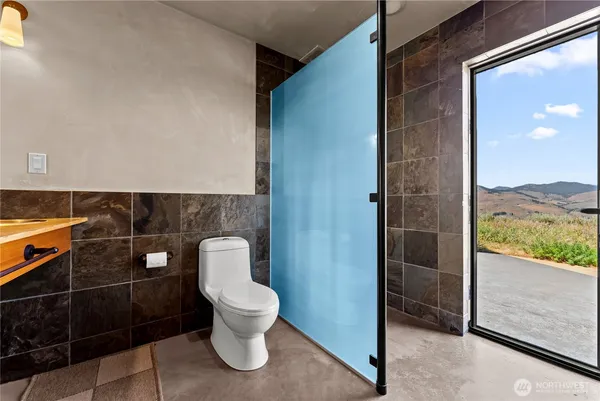a white toilet sitting next to a bathroom sink
