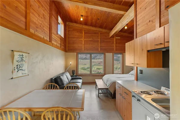 a bedroom with a bed couch and a window