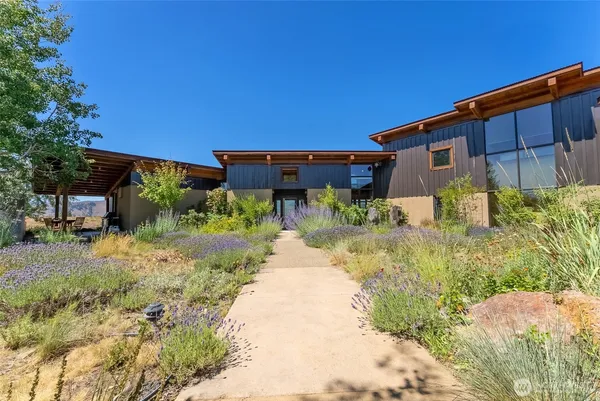 a backyard of a house with yard and outdoor seating