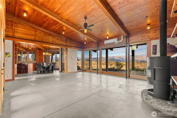a view of a hall with floor to ceiling windows and painted walls