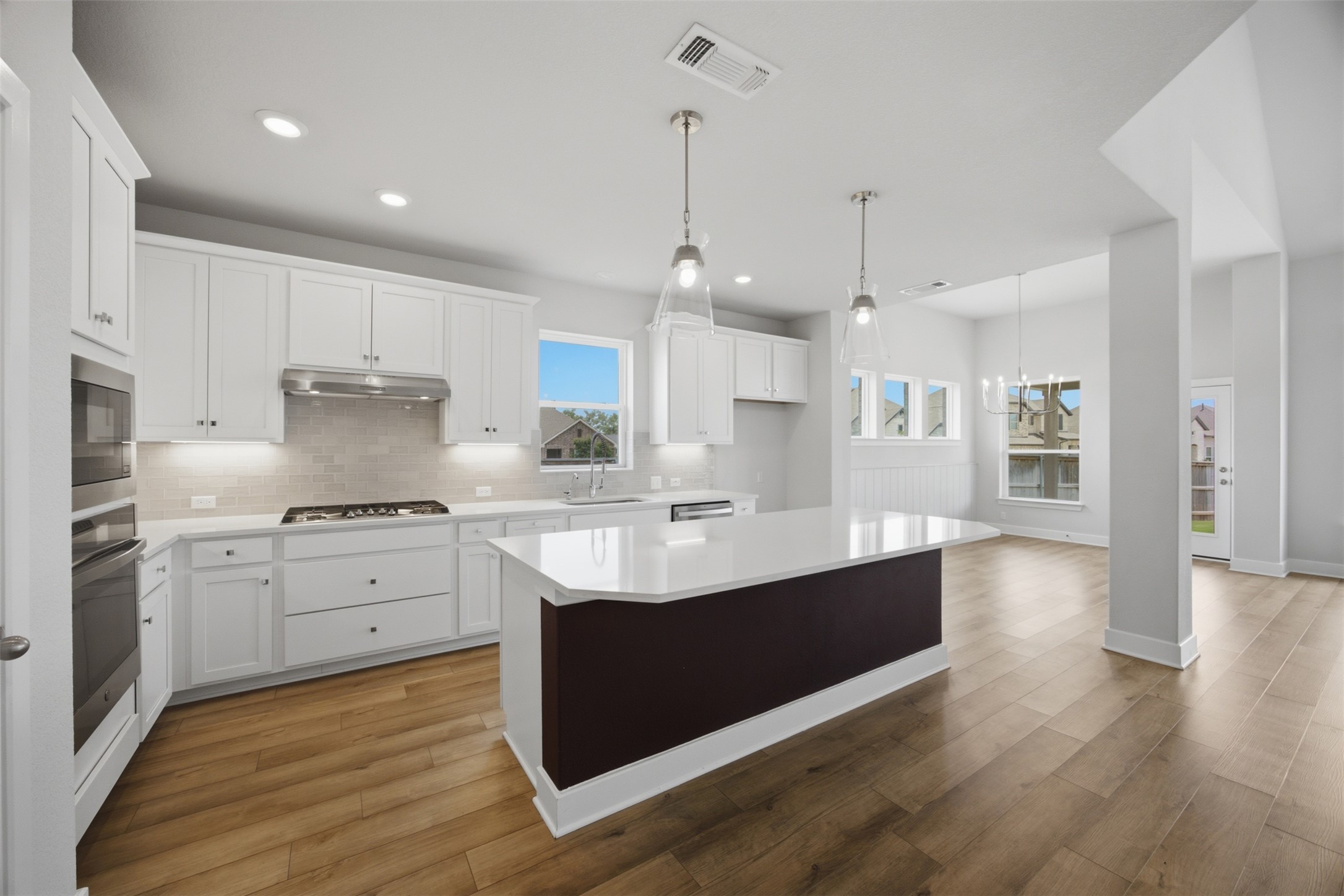 2101 Little Snake Way Georgetown, TX 78633 - Photo 11 of 37 Bright and airy, this kitchen features a central island perfect for gathering and culinary creations.