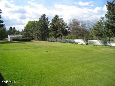 17161 Summitview Road Cowiche, WA 98923 - Photo 21 of 28 a view of a green field with trees in the background