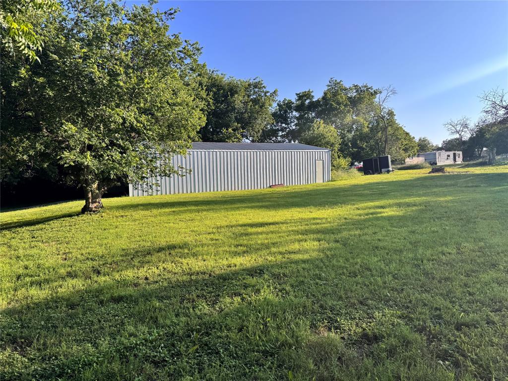 1002 6th Street Blanket, TX 76432 - Photo 8 of 16 Expansive grassy yard with mature trees