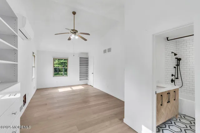 a view of a chandelier fan and entryway