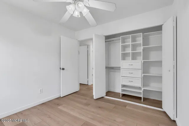 an empty room with closet and windows