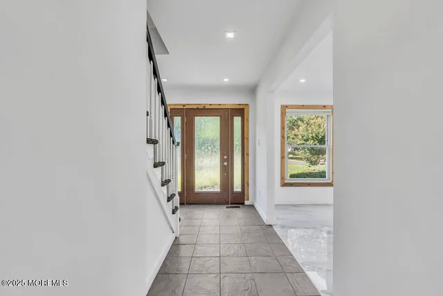 a view of a hallway with a livingroom and a hallway