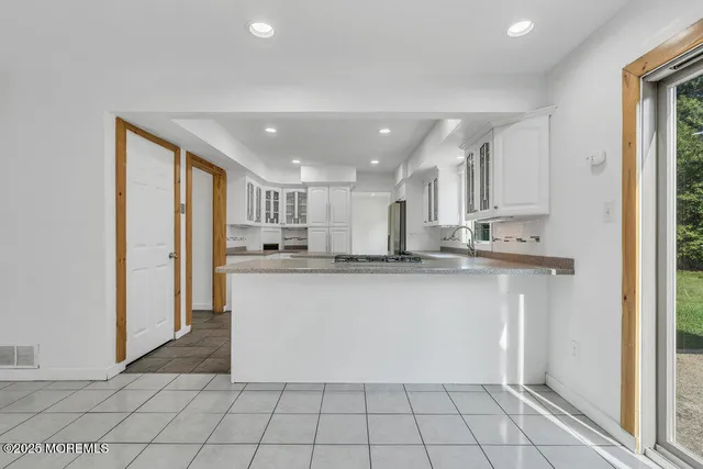 a kitchen with stainless steel appliances granite countertop a refrigerator and a sink