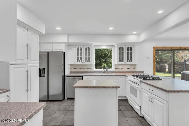 a kitchen with a sink stove and refrigerator