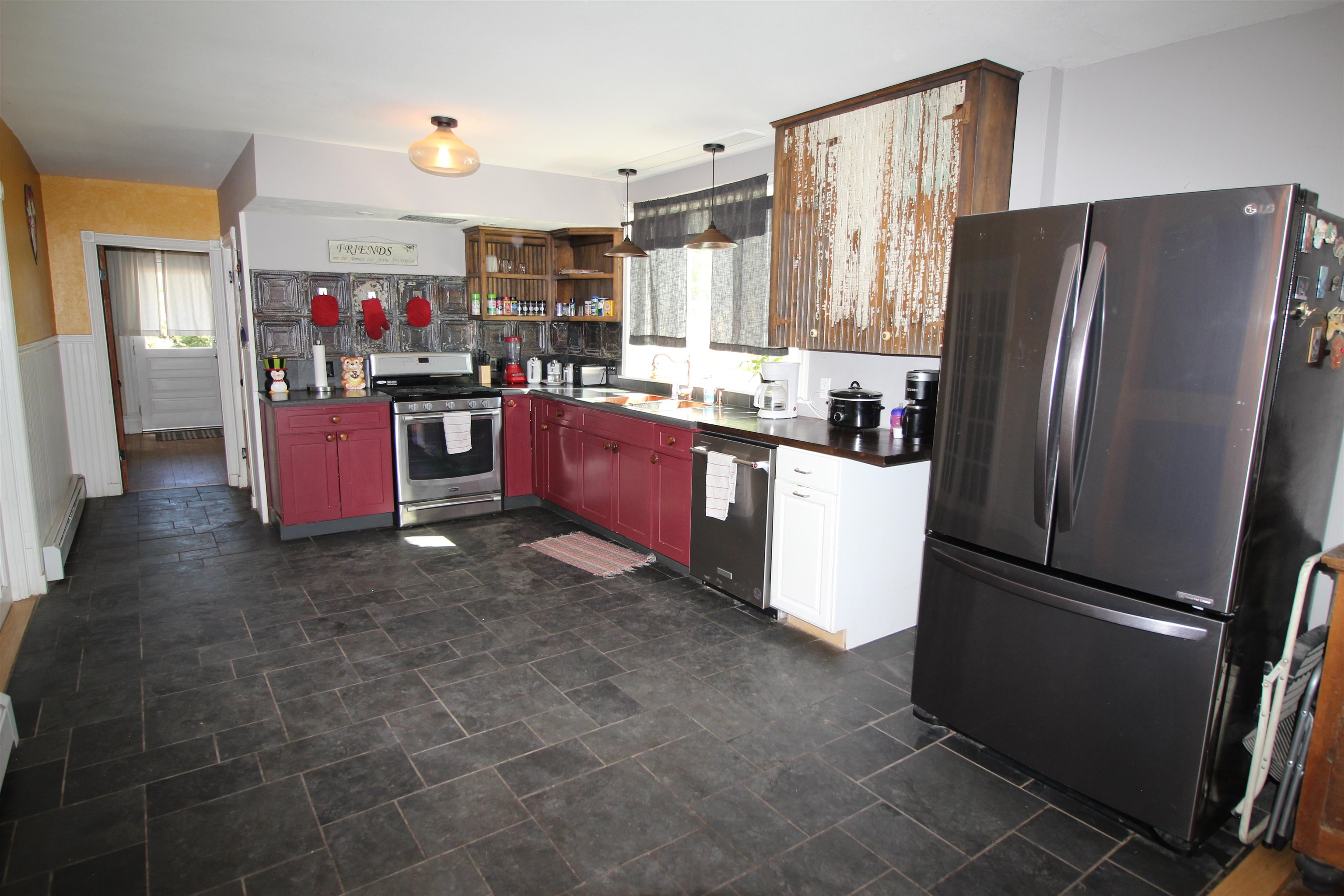 1150 East 7th Street Delta, CO 81416 - Photo 10 of 32 a kitchen with granite countertop a refrigerator and a stove top oven